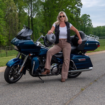 Woman sitting on a motorcycle in the MLV2 Hit Air safety vest.