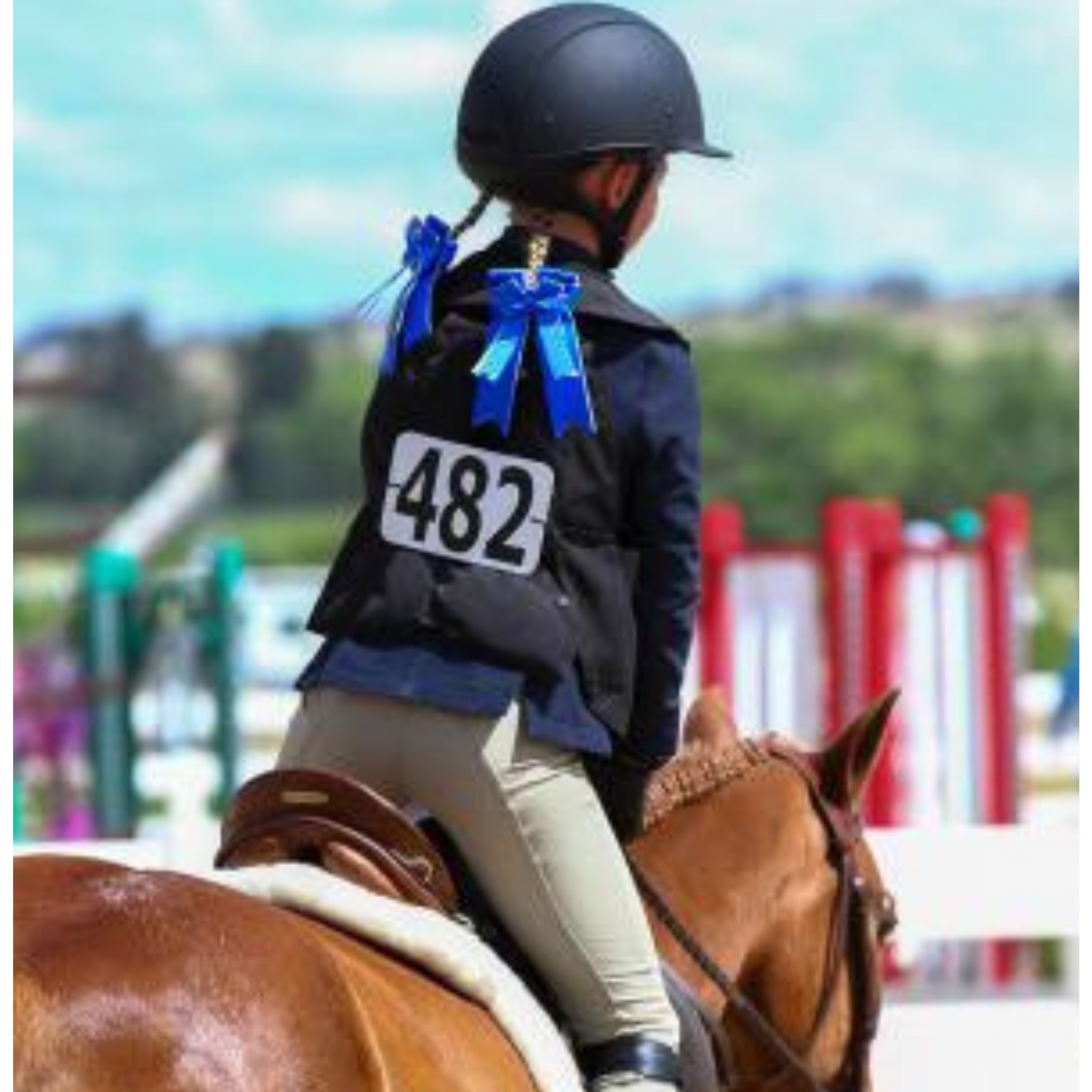 An equestrian rider (child) in SKV airbag vest for enhanced safety on a horse.
