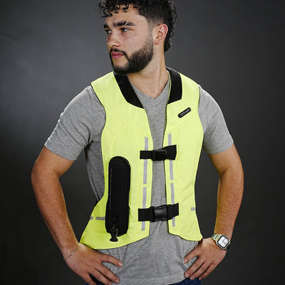 Man wearing a high-visibility ST safety vest against a dark background