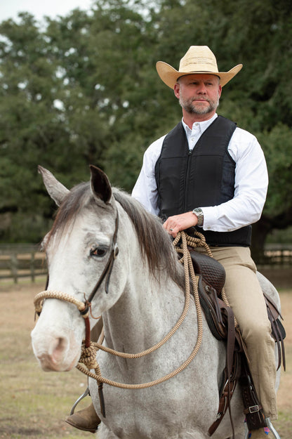 A western equestrian on a horse wearing a Hit Air inflatable airbag system. 